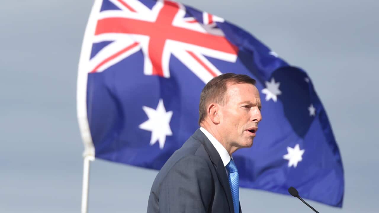 Prime Minister Tony Abbott with an Australian flag