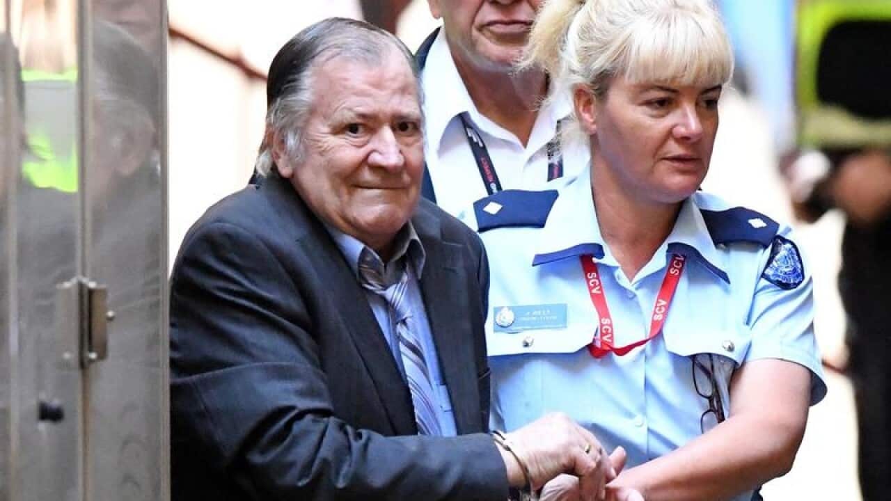 Gregory Keith Davies is escorted by into court