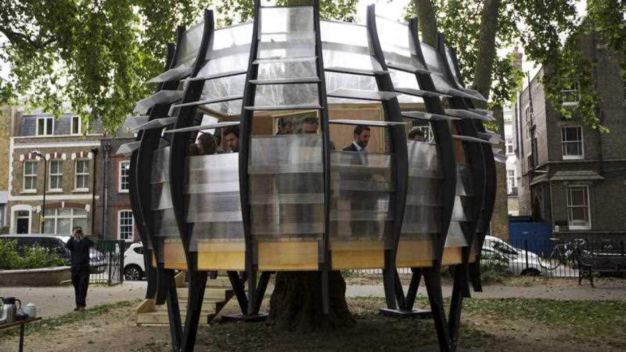 TREExOFFICE in Hoxton Square, London, was built around a tree and has eight workstations available for hire. (AP Photo/Matt Dunham)