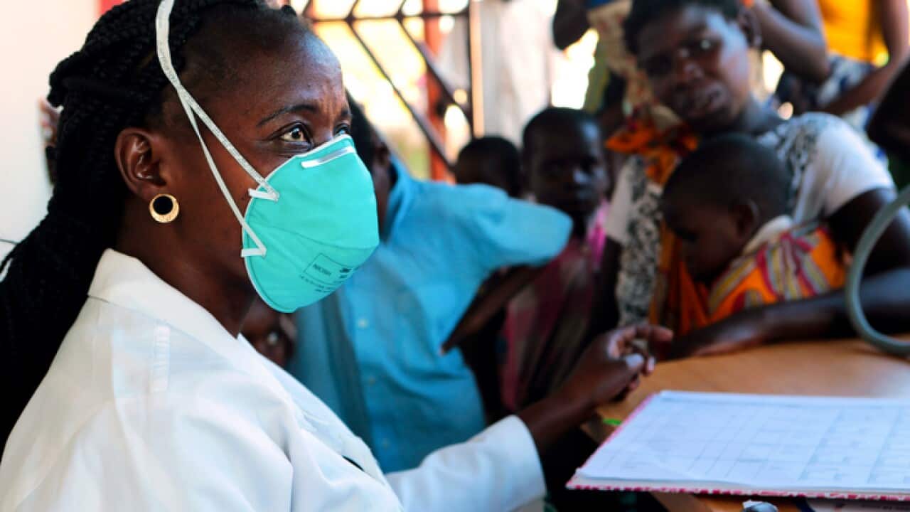 A nurse attends to displaced people suspected to have cholera in a compound in Beira, in Mozambique