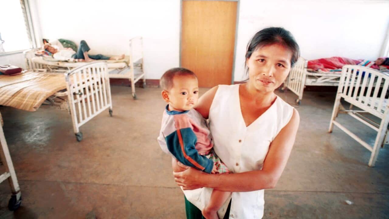 A Laotian mother holds her sickly child in the main ward of the hospital in Vang Vieng, Laos (AAP Image-AP Photo-David Longstreath)