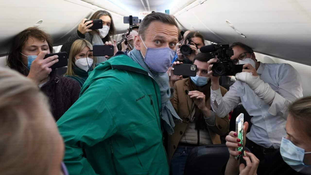 Alexei Navalny is surrounded by journalists prior to his flight to Moscow in the Airport Berlin Brandenburg (BER) in Schoenefeld, Germany, on 17 January.