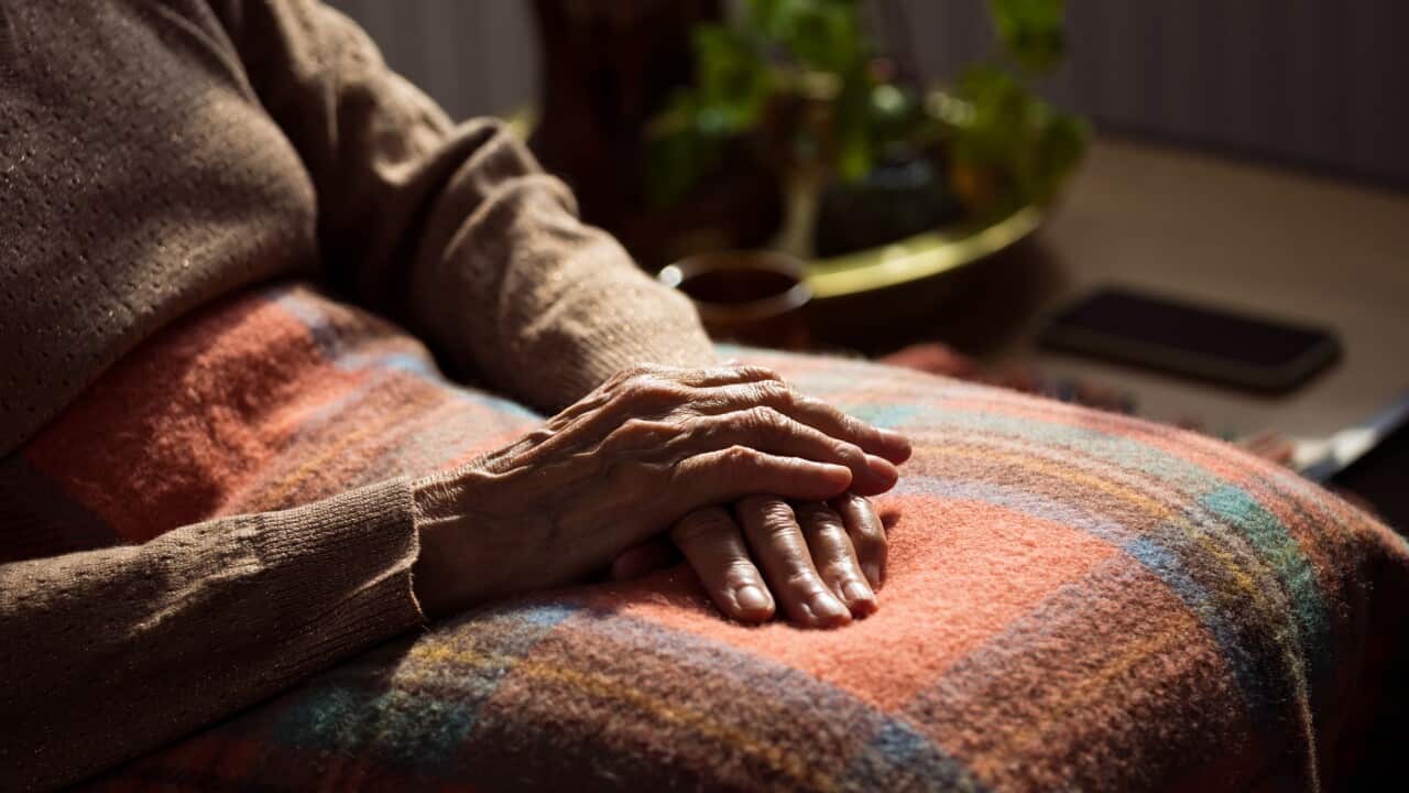 Senior woman's hands on blanket
