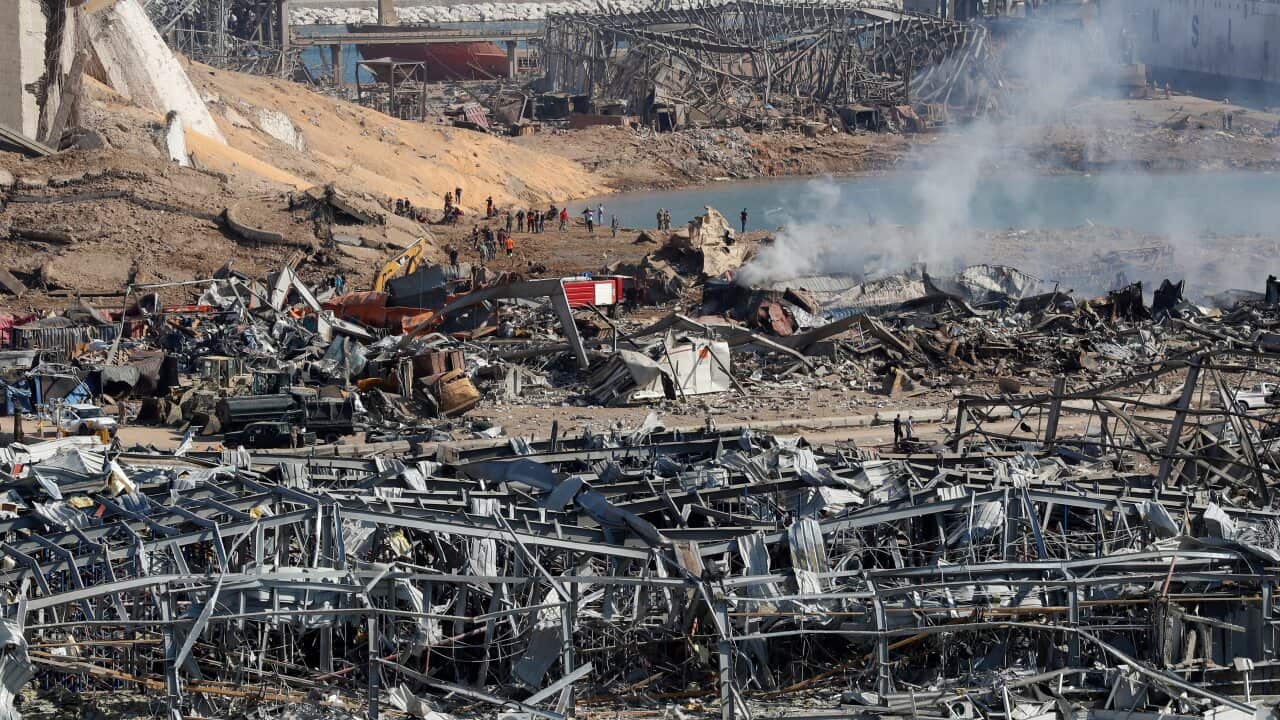 Rescue workers and security officers work at the scene of an explosion that hit the seaport of Beirut, Lebanon.