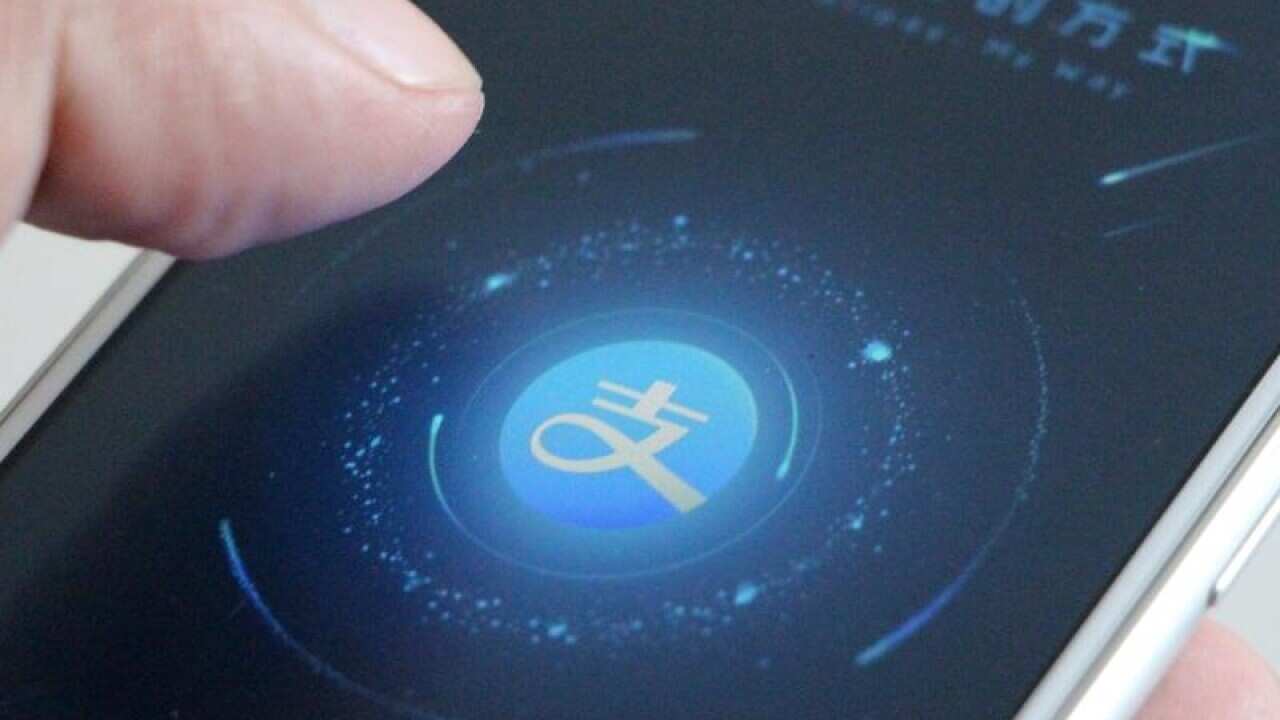 A file image of a mobile phone user using the Alipay app