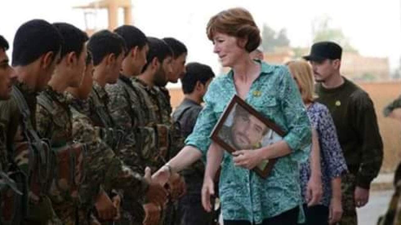 A photo which appears to show Reece Harding's mother Michelle meeting with Kurdish fighters in northern Syria.