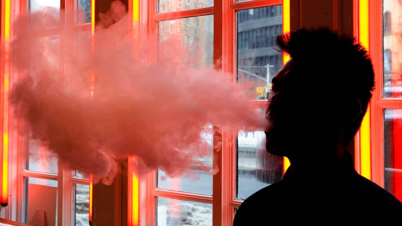 A patron exhales vapor from an e-cigarette at the Henley Vaporium in New York
