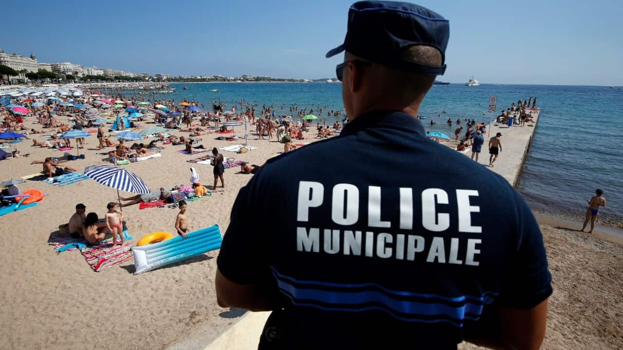 File image of a French police officer patrols on the beach of Cannes, in security measures after the Nice terror attack, in Cannes, France