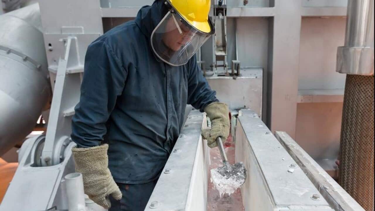 A man works on the new smelting process