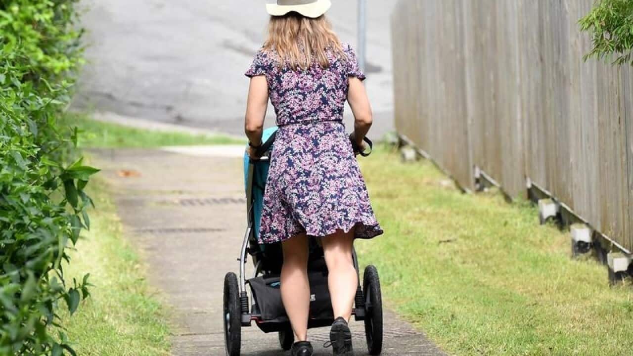 A mother pushes a stroller in Brisbane.