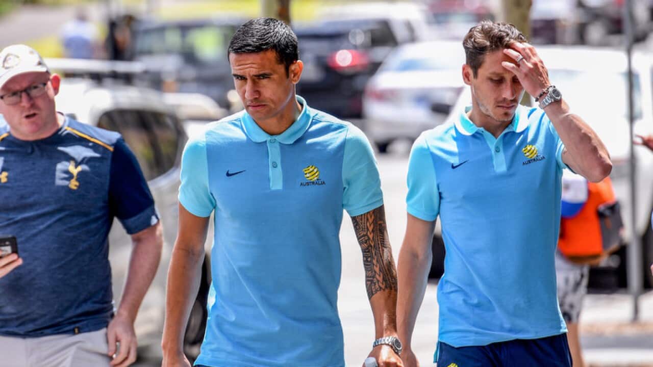 Socceroos players Tim Cahill (centre) and Mark Milligan arrive for a press conference in Sydney, Monday, November 13, 2017.