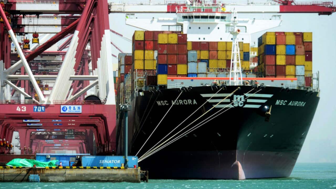 Containers being loaded on a cargo ship at the port in Qingdao in east China's Shandong province