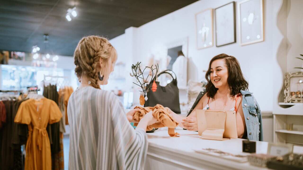 Latina Boutique Store Owner At Checkout Counter