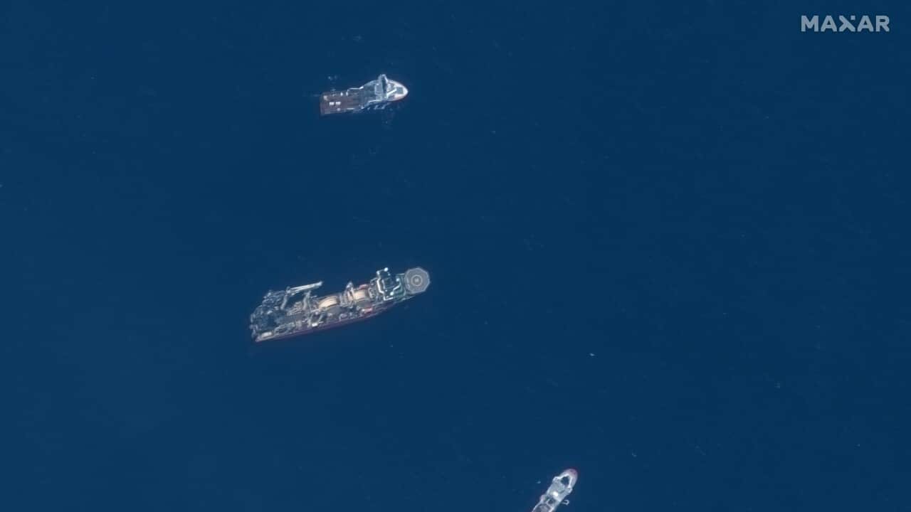 A birds-eye view of three large ships on the ocean's surface.