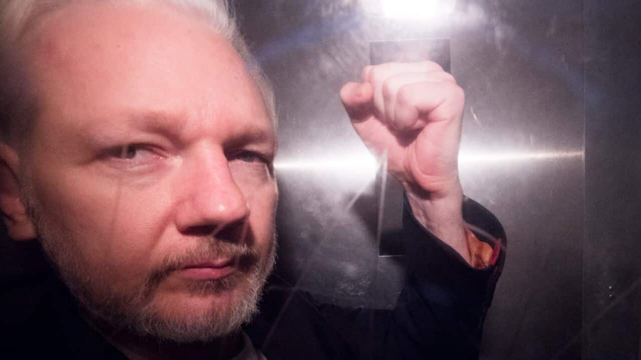 Wikileaks co-founder Julian Assange, in a prison van, as he leaves Southwark Crown Court in London, Britain (AAP)
