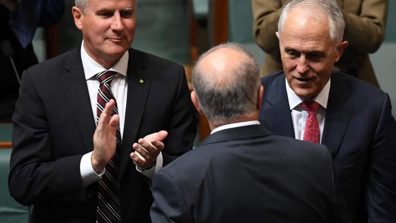 Deputy PM Michael McCormack applauds Scott Morrison's budget speech.