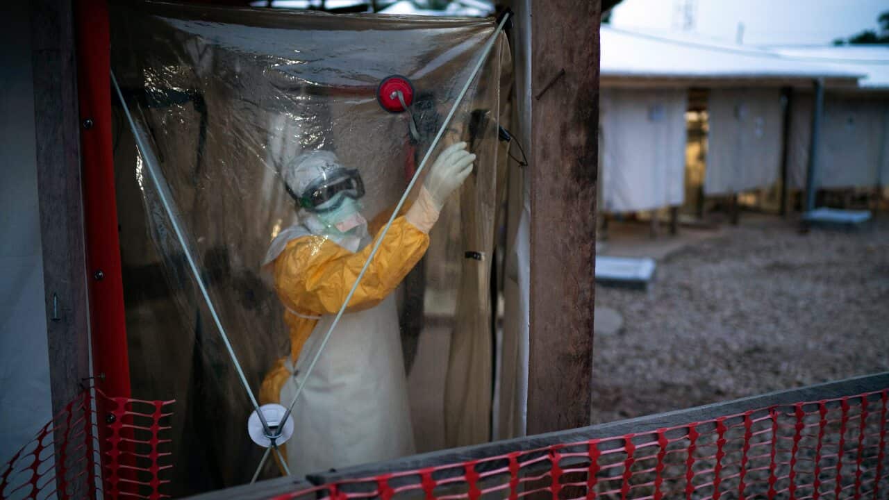 A health worker wearing protective suits enters an isolation pod to treat a patient at a treatment centre in Beni, Congo DRC.