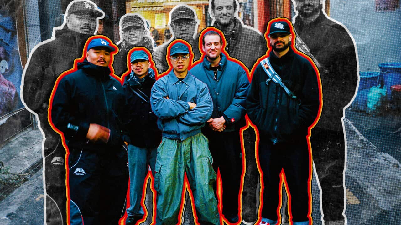 Five men standing on a street. There's an orange outline around them.