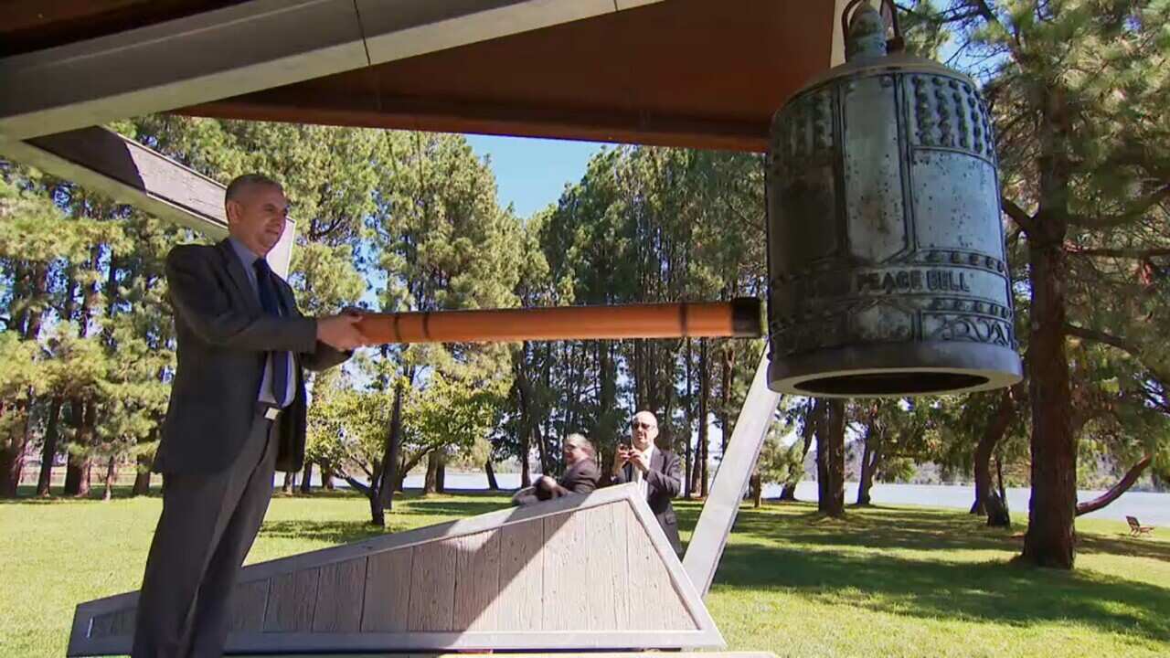 The peace bell is rung at a commemoration in Canberra