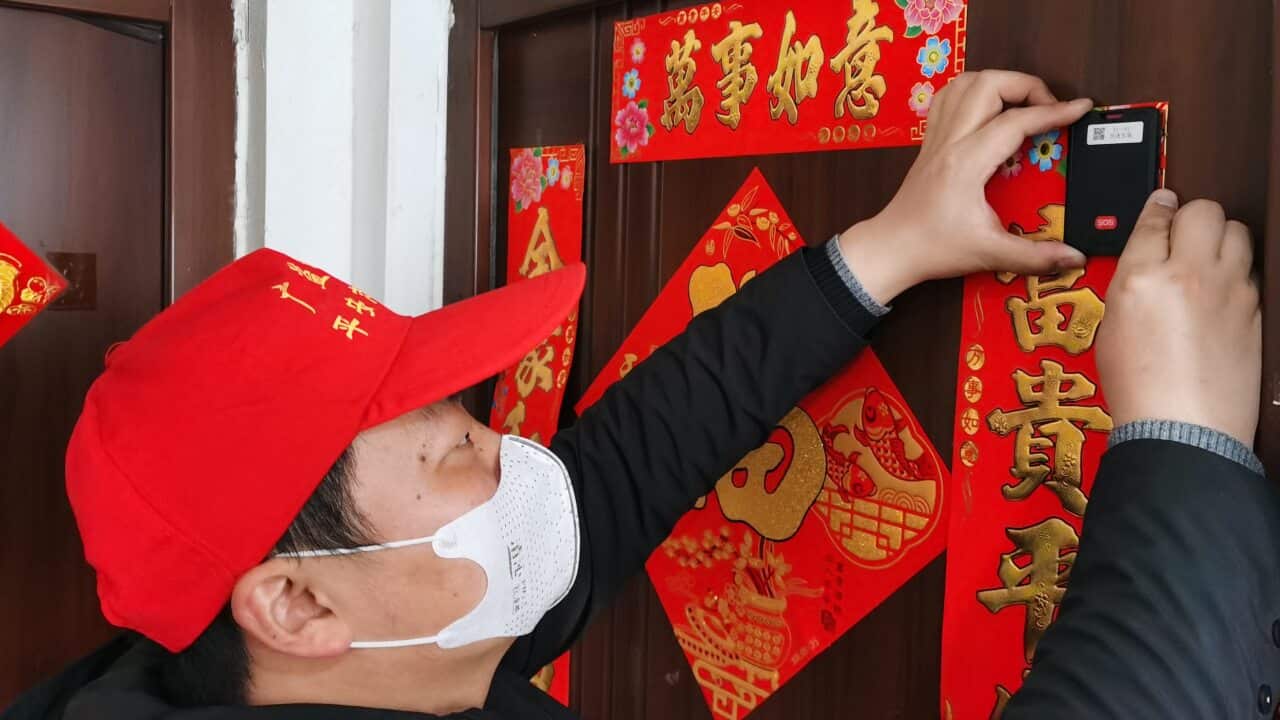 Workers installing an e-seal to monitor suspected novel coronavirus pneumonia patients under isolation in Wuxi, China.