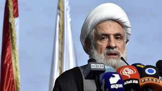 A man wearing a turban holding a press conference