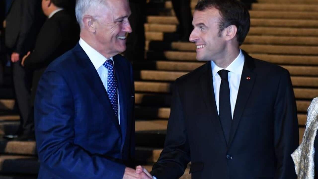 Emmanuel Macron shakes greets Malcolm Turnbull in Sydney.