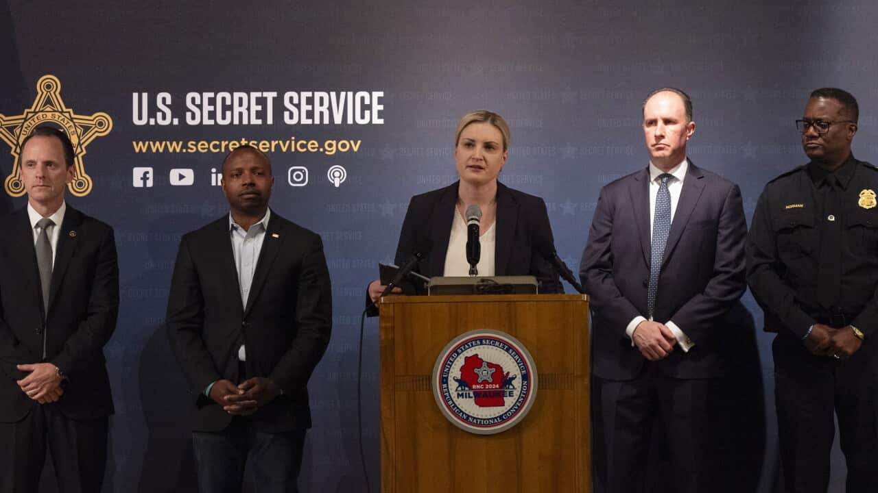A Secret Service official speaks at a podium.