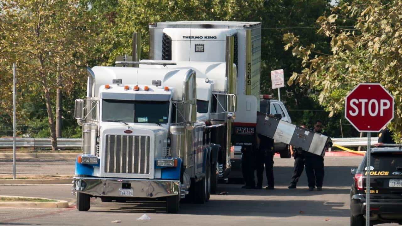 Officials tow a truck that was found to contain 38 suspected illegal immigrants in San Antonio, Texas, USA, 23 July 2017.