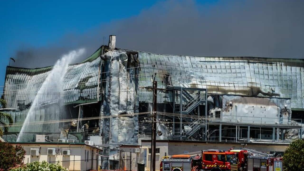 Emergency services work on a large fire burning at an abattoir