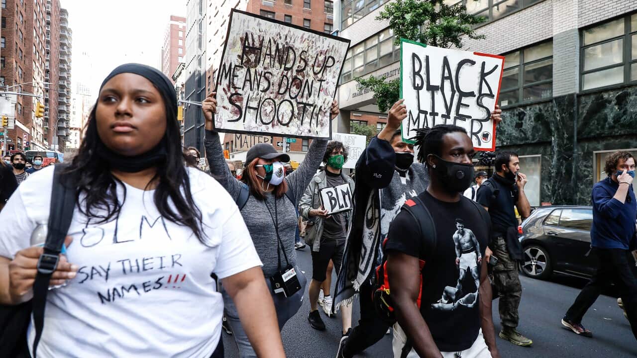 Protesters hold placards as they take part during a demonstration in response to the death of a Minneapolis man George Floyd.