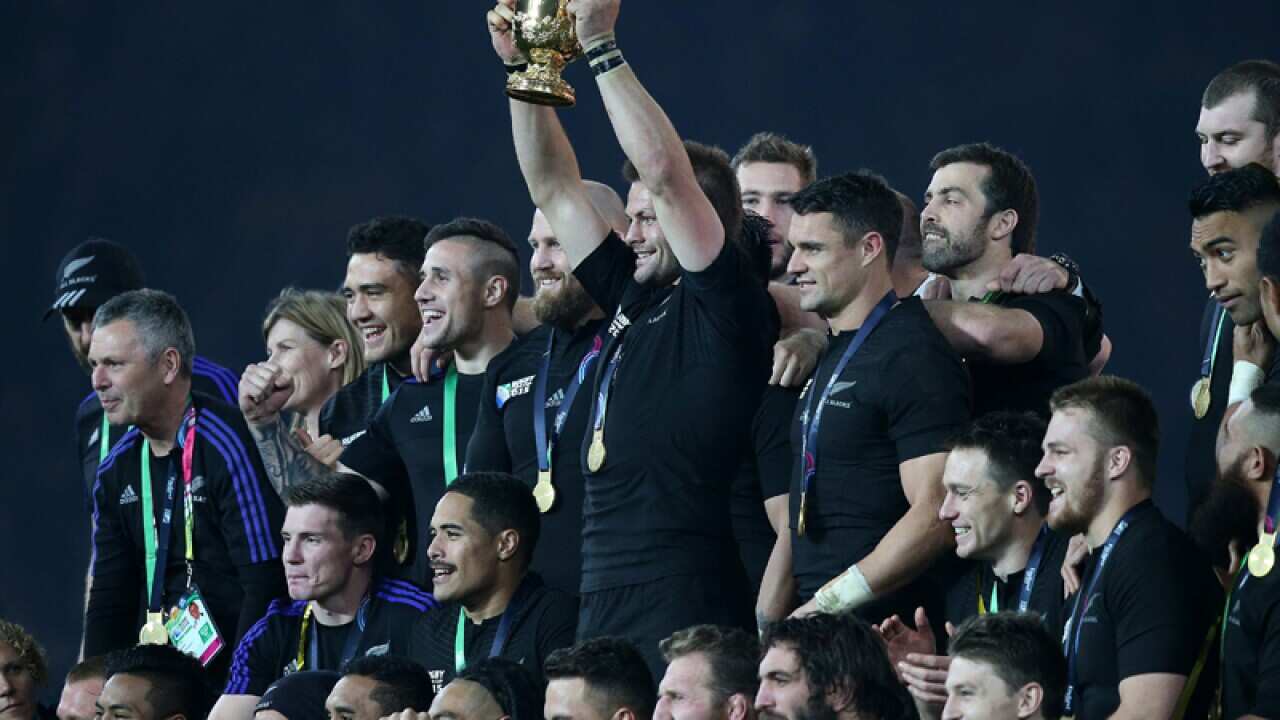 New Zealand captain Richie McCaw lifts the Webb Ellis Cup
