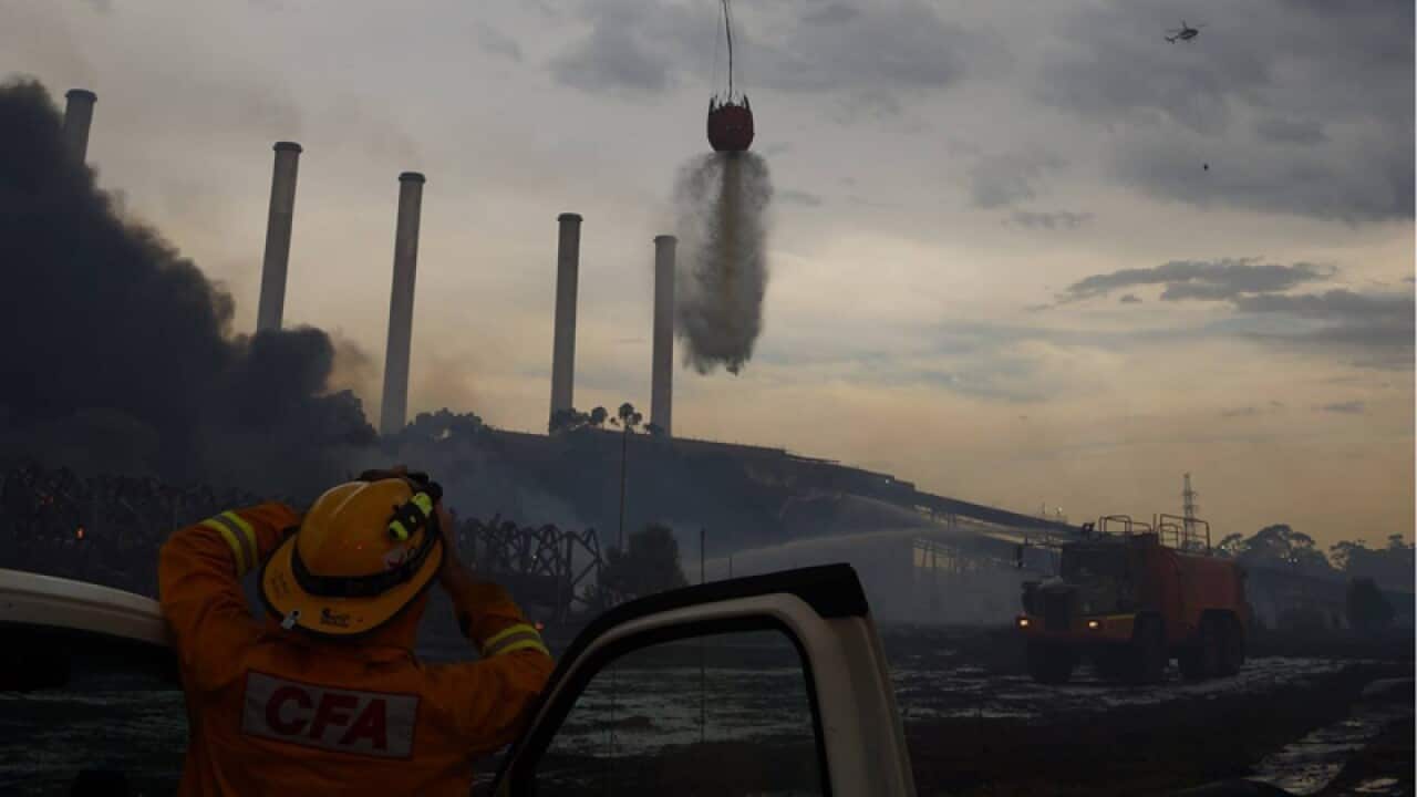 a helicopter dropping water on a fire at the Hazelwood coal mine