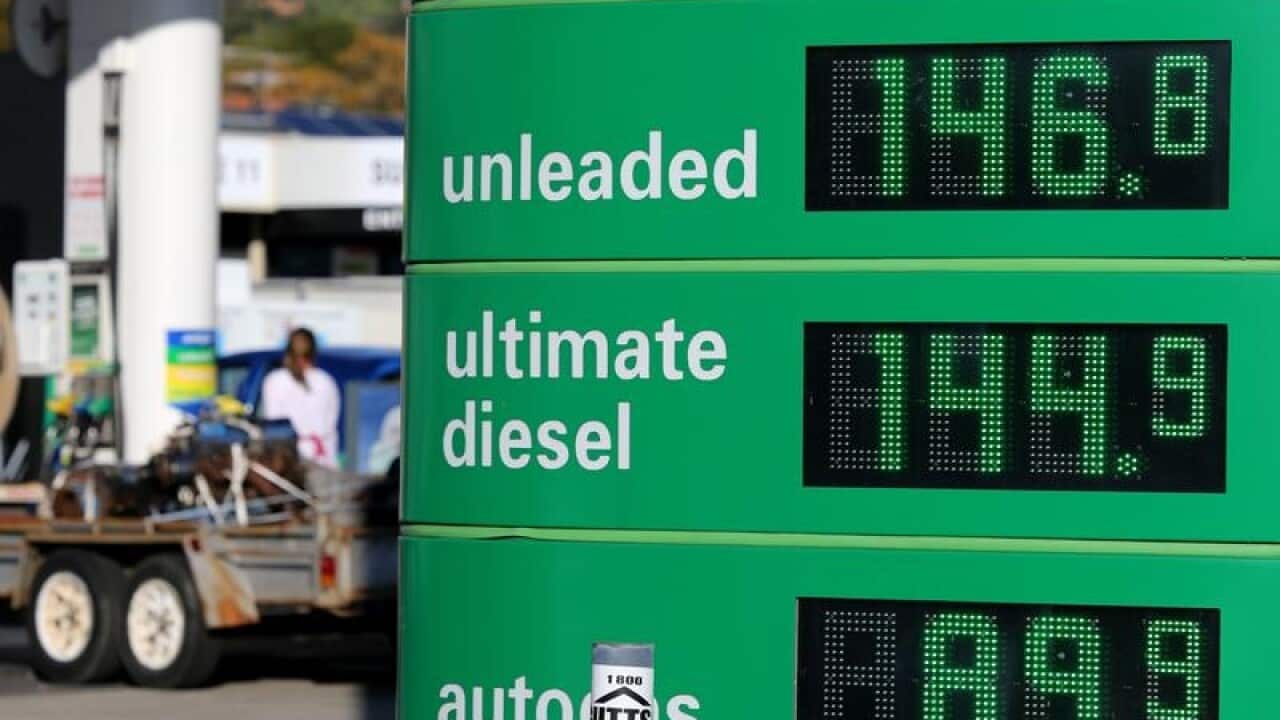 An electronic sign displays petrol prices at a service station