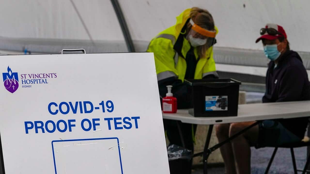 A woman waits to receive a COVID-19 test in the eastern suburbs of Sydney Tuesday, Sept. 14, 2021.