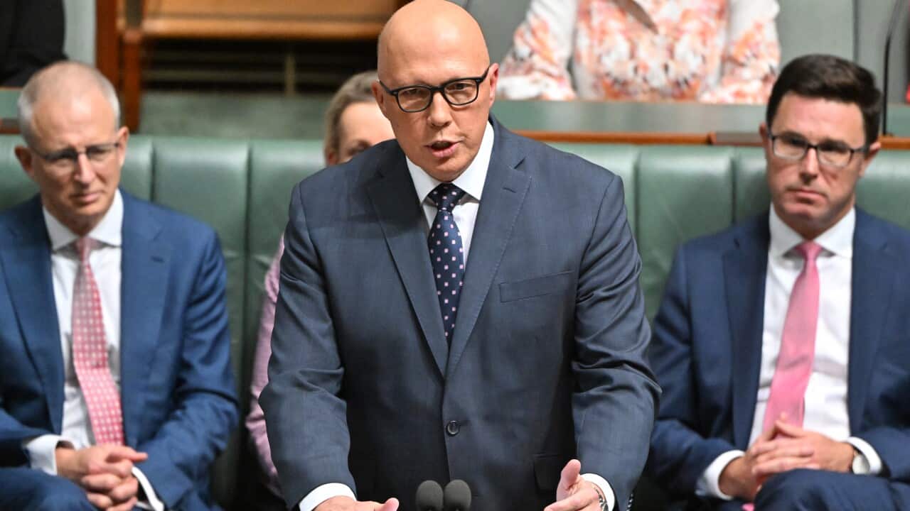 A man in suit and glasses speaks at the House of Representatives dispatch box.