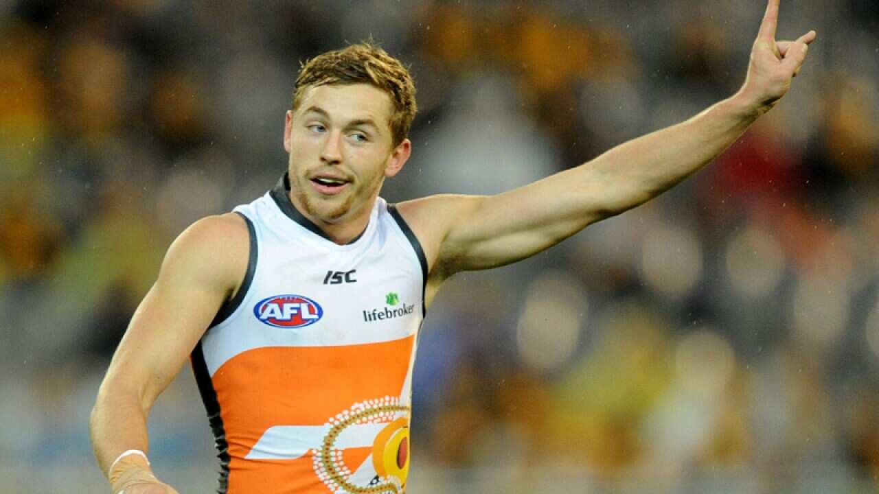Phil Davis of GWS celebrates after kicking a goal,