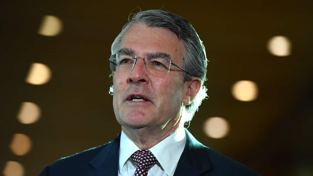 Mark Drefys is mid-speech in a suit