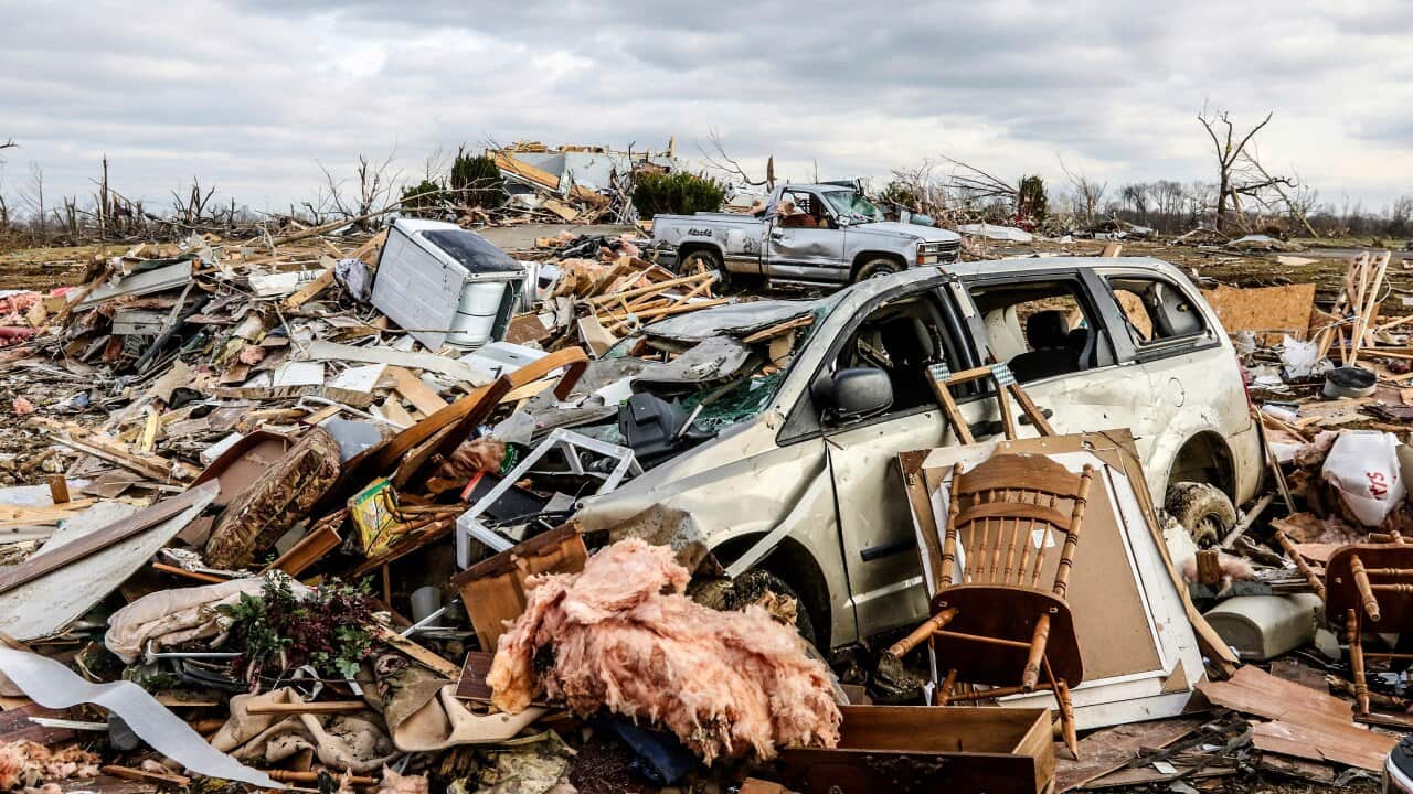 Damaged vehicles and personal property are strewn over a wide area along Kentucky 81, Saturday, Dec. 11, 2021, in Bremen, Ky, after a devastating tornado swept through the area on Friday night. (Greg Eans/The Messenger-Inquirer via AP)