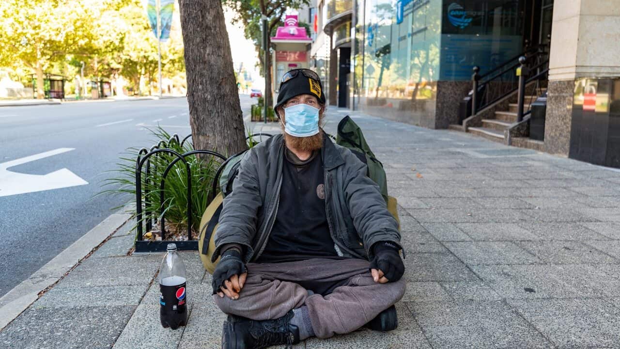 A homeless man wearing a mask in Perth in February