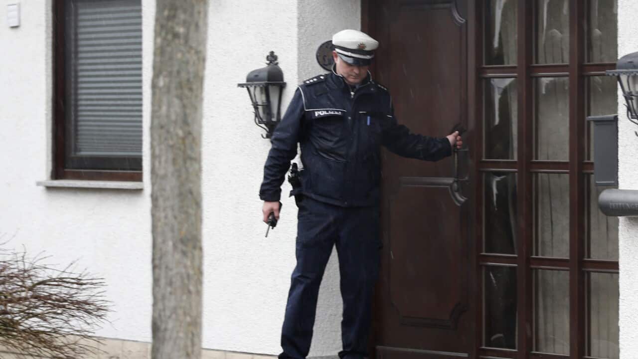 A police officer leaves a house in Montabaur, Germany, Thursday, March 26, 2015 where the family of Andreas Lubitz lives. Lubitz was the copilot on flight Germanwings 9525 that crashed with 150 people on board on Tuesday in the French Alps.