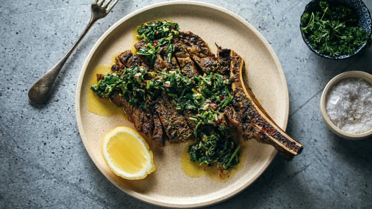 Rib eye on the bone with charred herb salsa