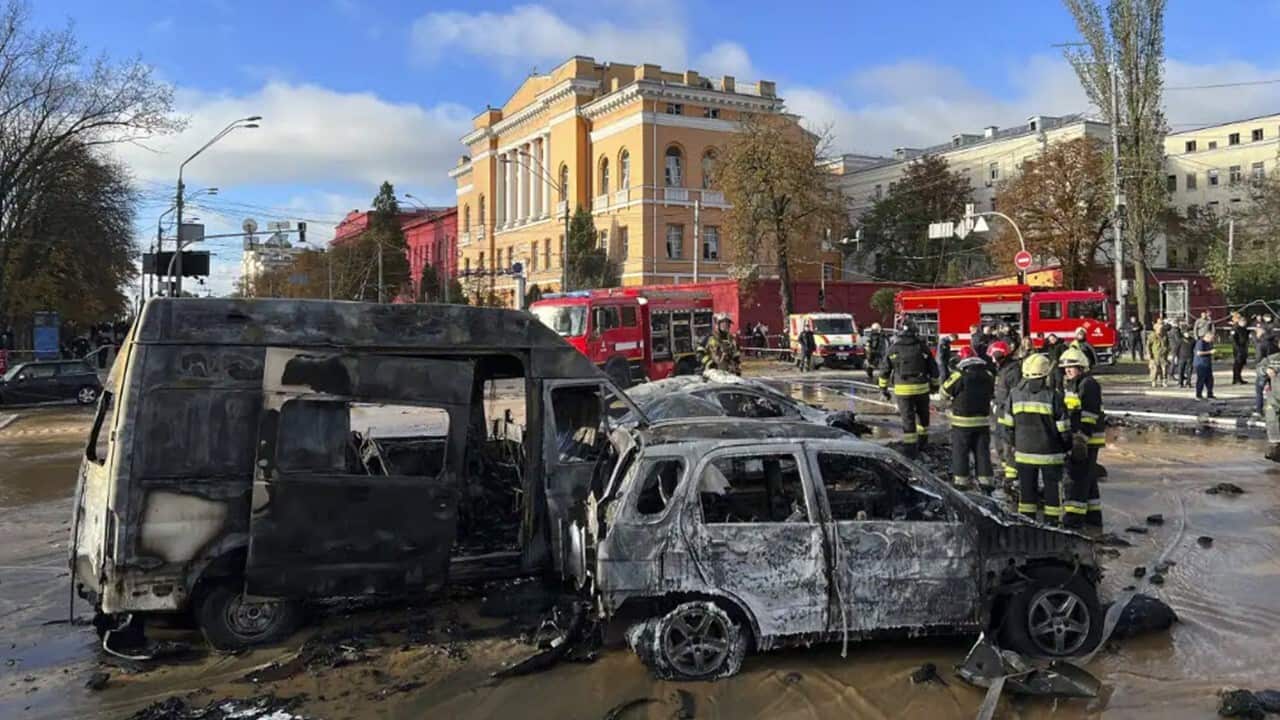 Rescue workers survey the scene of a Russian attack on Kyiv.jpg