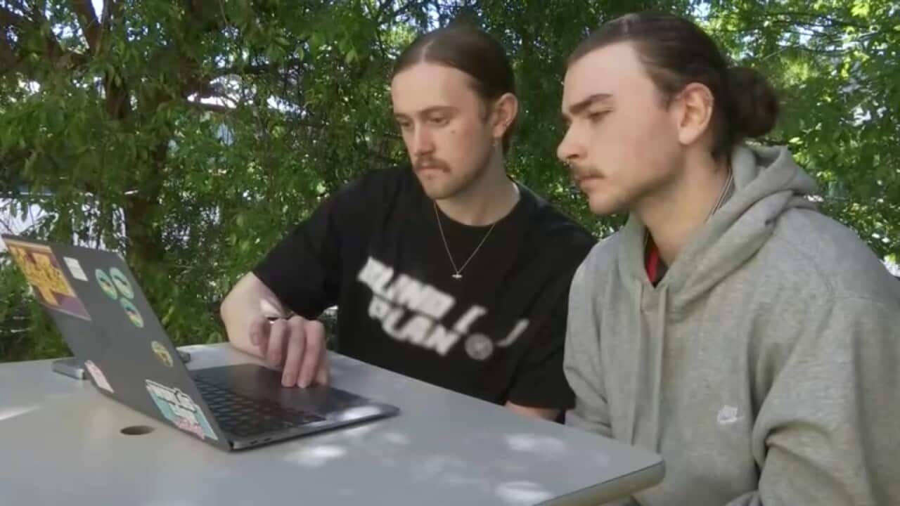 Two men looking at laptop