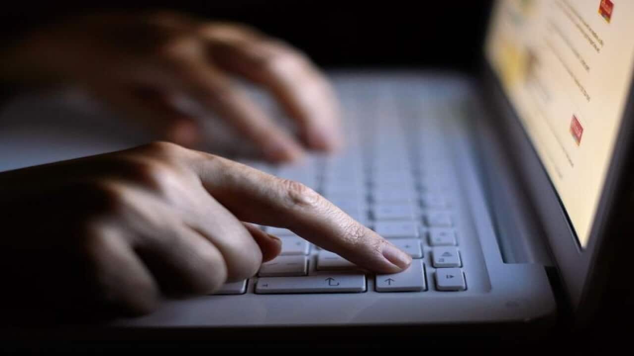 Fingers using laptop keyboard