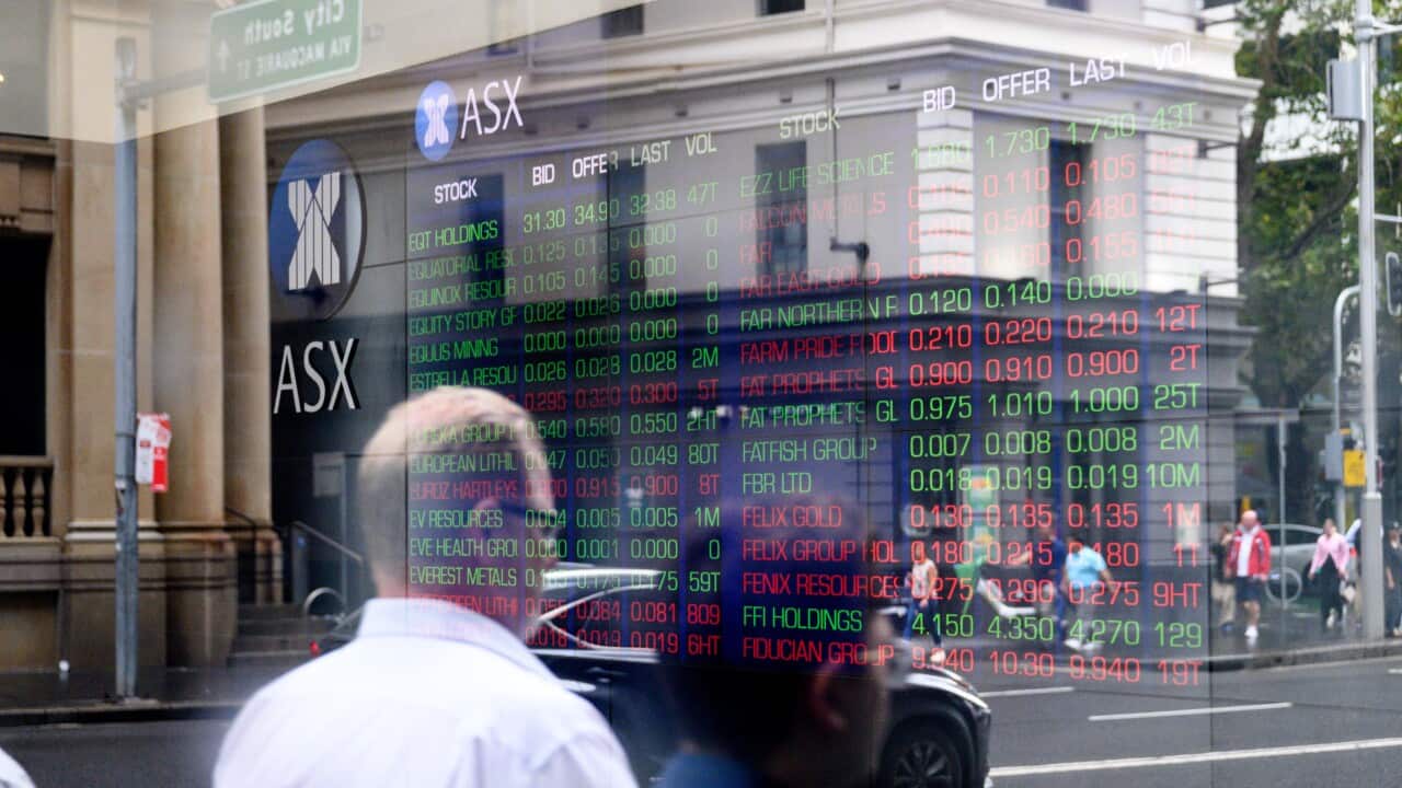 A reflection of people walking past the ASX