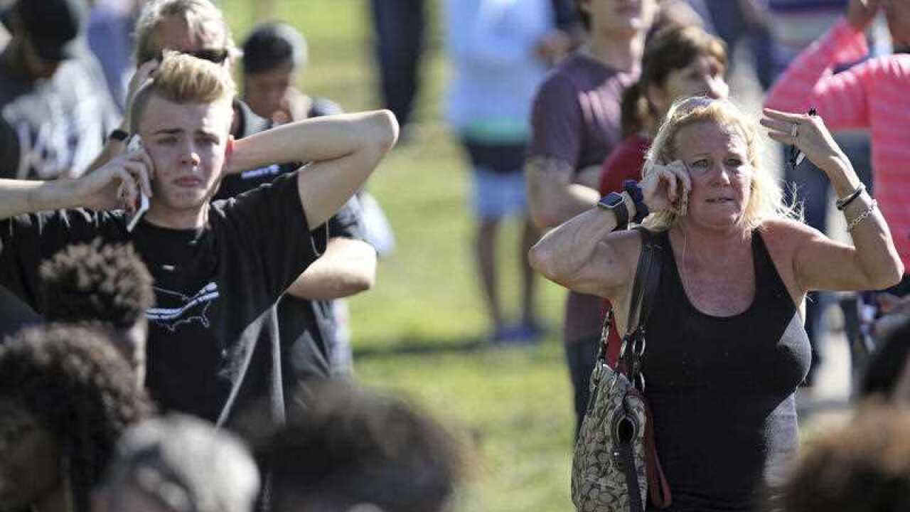 Waiting for word from students anxious family members gather at Coral Springs Drive and the Sawgrass Expressway, just south of the campus ,following a shooting at Marjory Stoneman Douglas High School in Parkland.