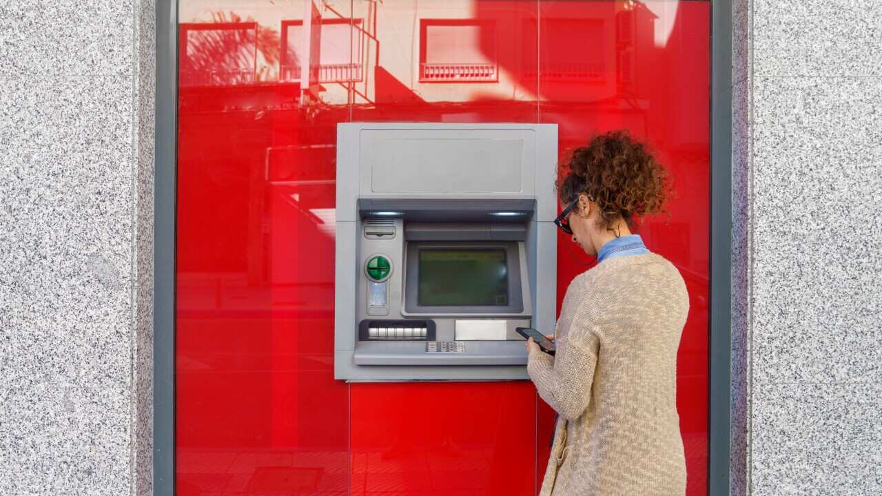 Latin woman using ATM