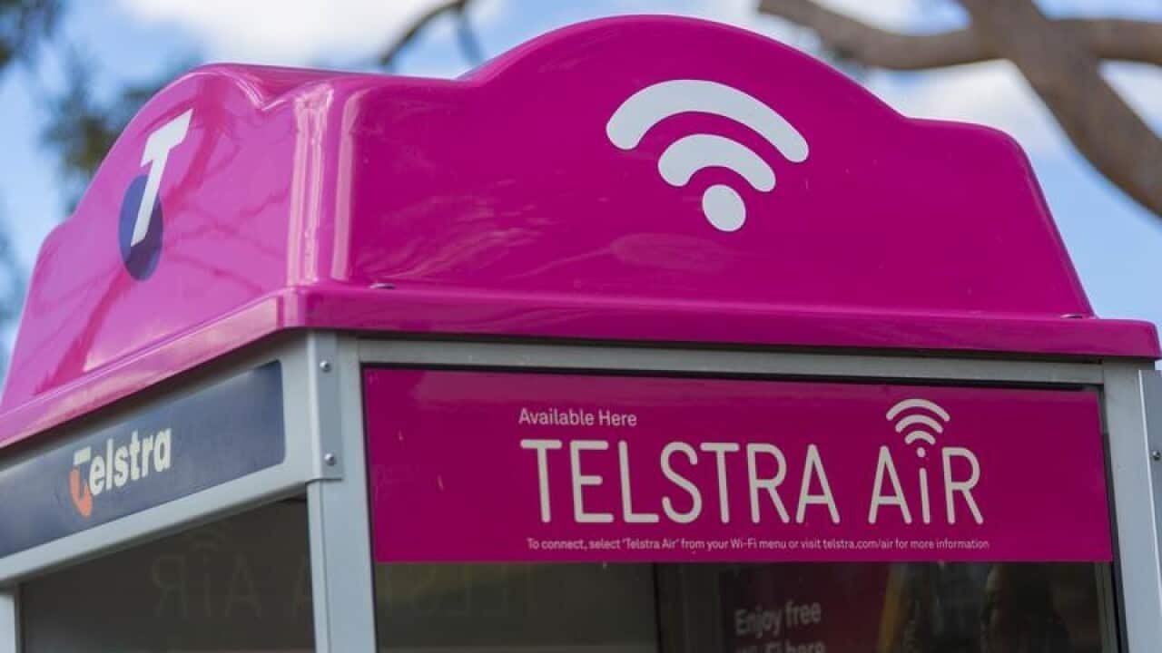 A file image of Telstra signage on a phone booth in Brisbane