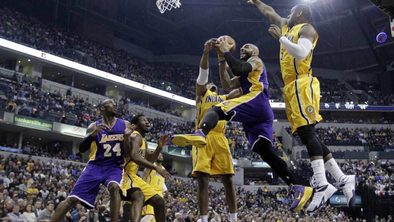 Lakers' Carlos Boozer puts up a shot against Pacers' David West