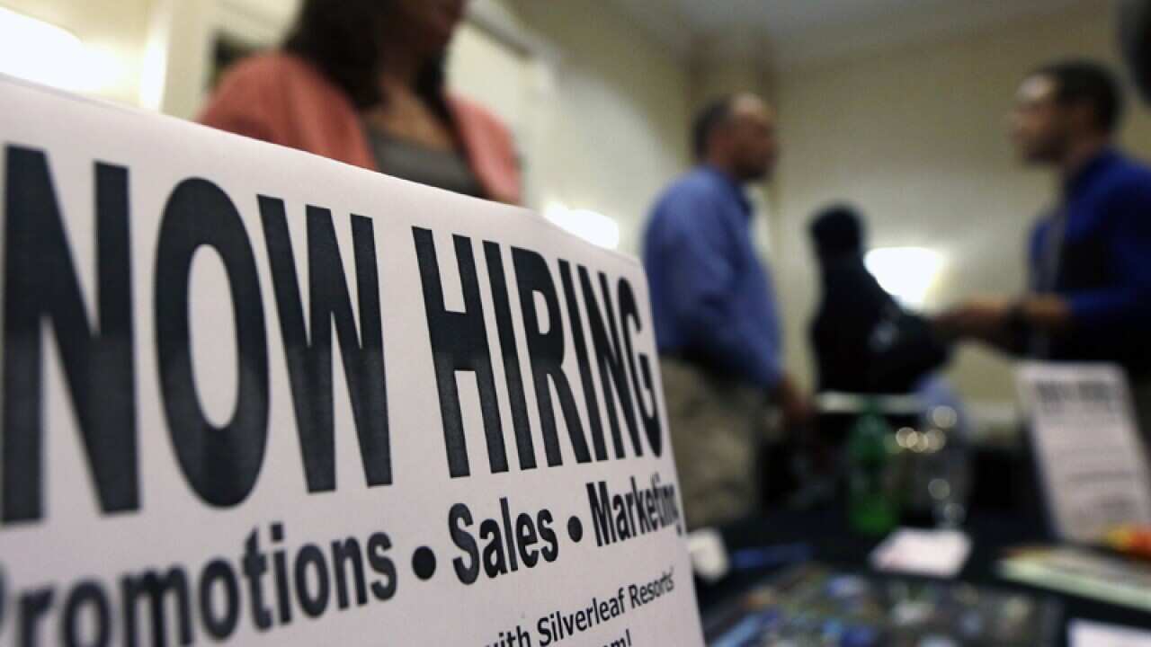 a sign attracts job-seekers during a job fair